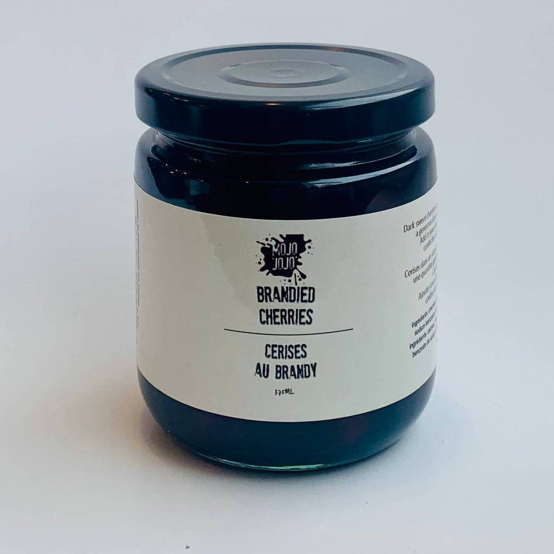 Jar of brandied cherries on a white background