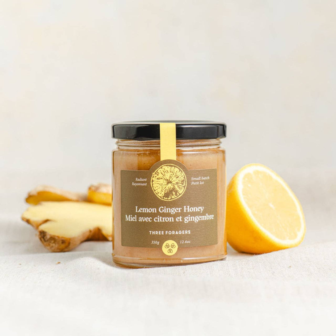 Jar of Lemon Ginger Infused Honey by Three Foragers, 350g, showcasing the honey with lemon and ginger slices in a glass jar.