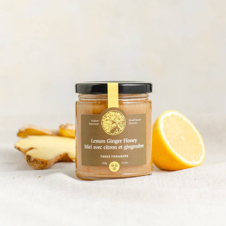 Jar of Lemon Ginger Infused Honey by Three Foragers, 350g, showcasing the honey with lemon and ginger slices in a glass jar.