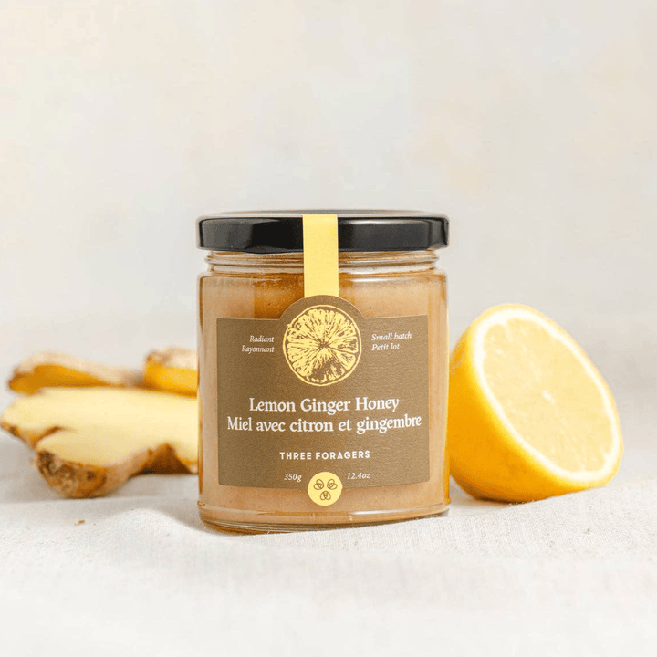 Jar of Lemon Ginger Infused Honey by Three Foragers, 350g, showcasing the golden honey with lemon and ginger infusion in a glass jar.