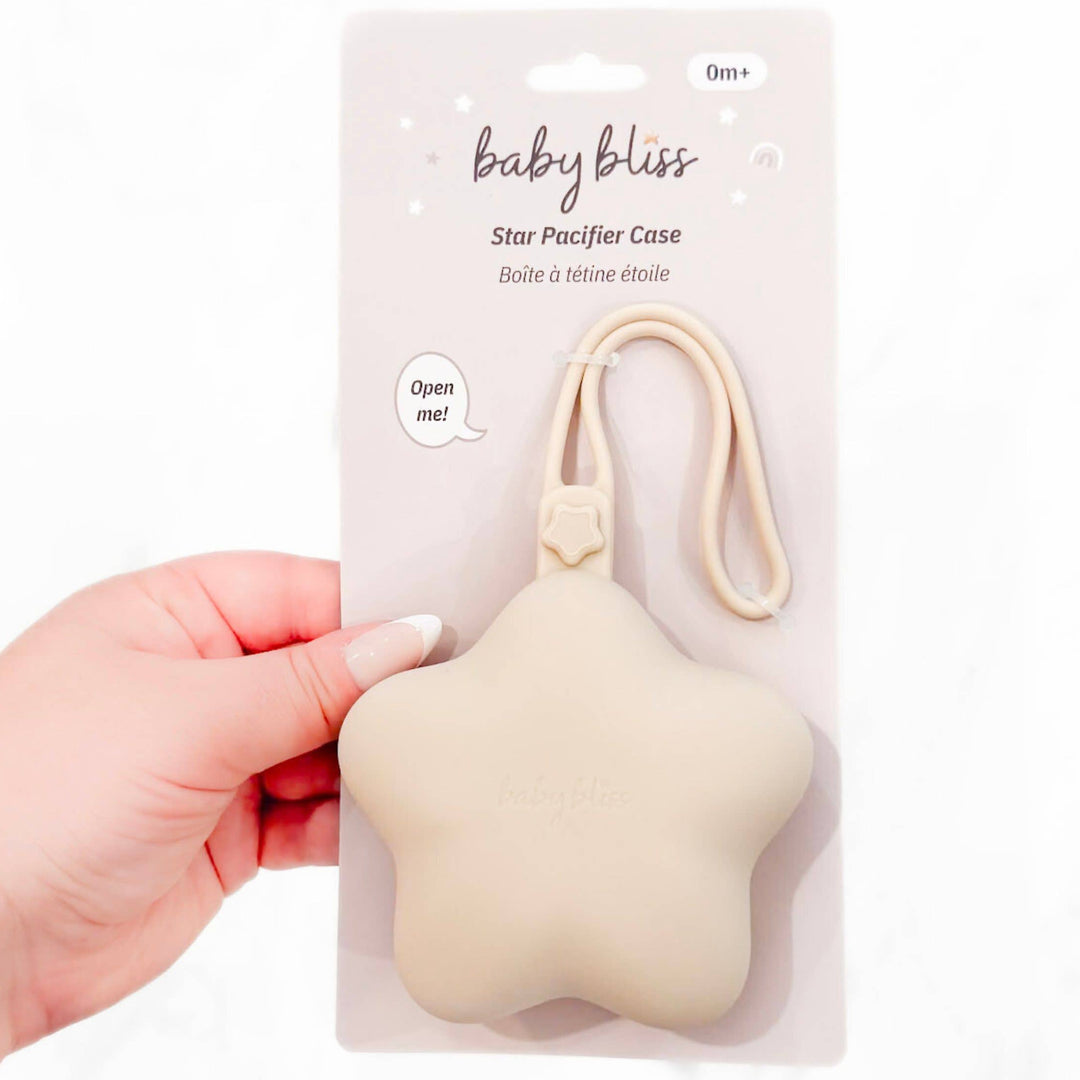 Star-shaped pacifier case in packaging held by a hand on a white background
