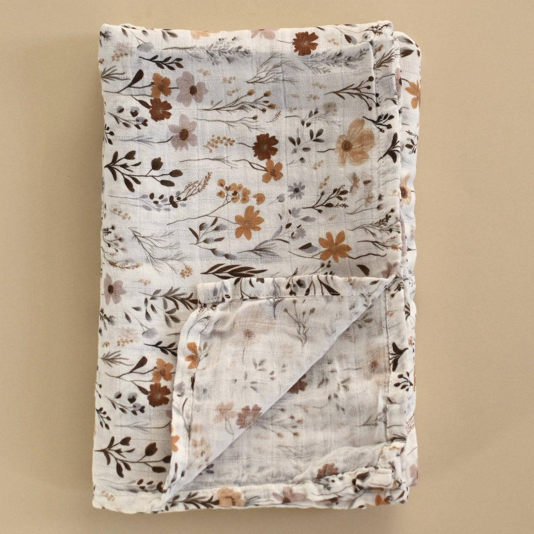 Floral-patterned blanket on a beige background