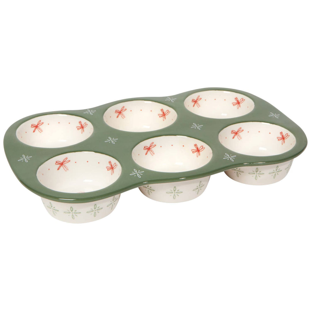 Muffin tin with decorative design on a white background