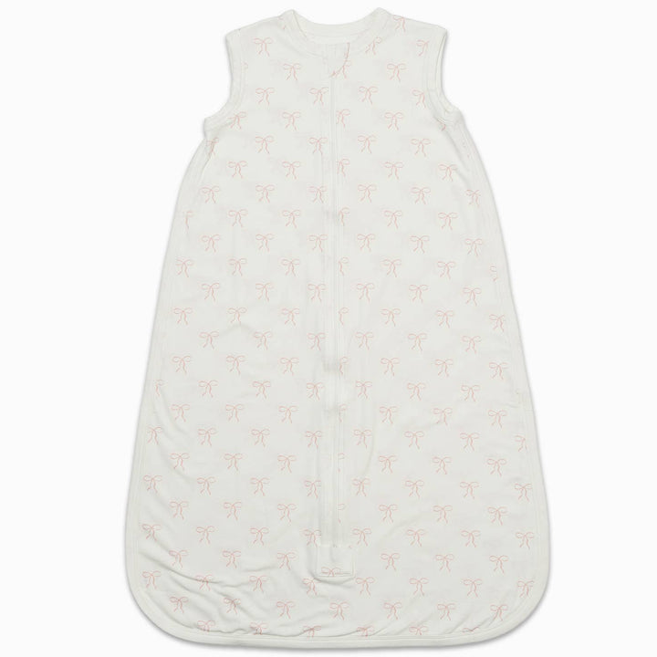 An off-white sleeveless baby sleep sack with a light pink palm tree pattern, shown flat against a white background.