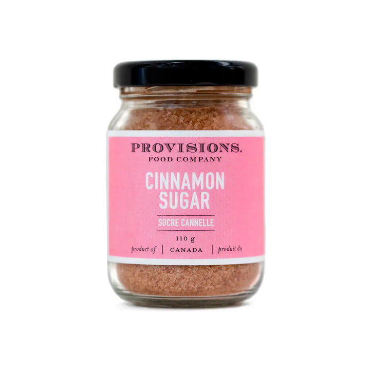A glass jar of Provisions Food Company Cinnamon Sugar with a pink label, containing 110g of product.