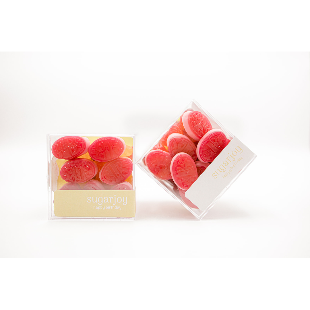 Two packages of red gummy candies on a white background