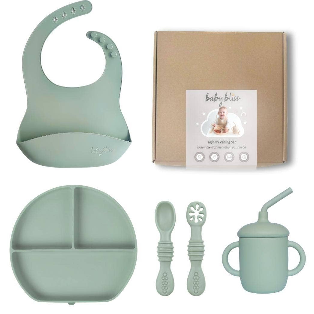 Baby feeding set with bib, plate, cups, and spoons on a white background