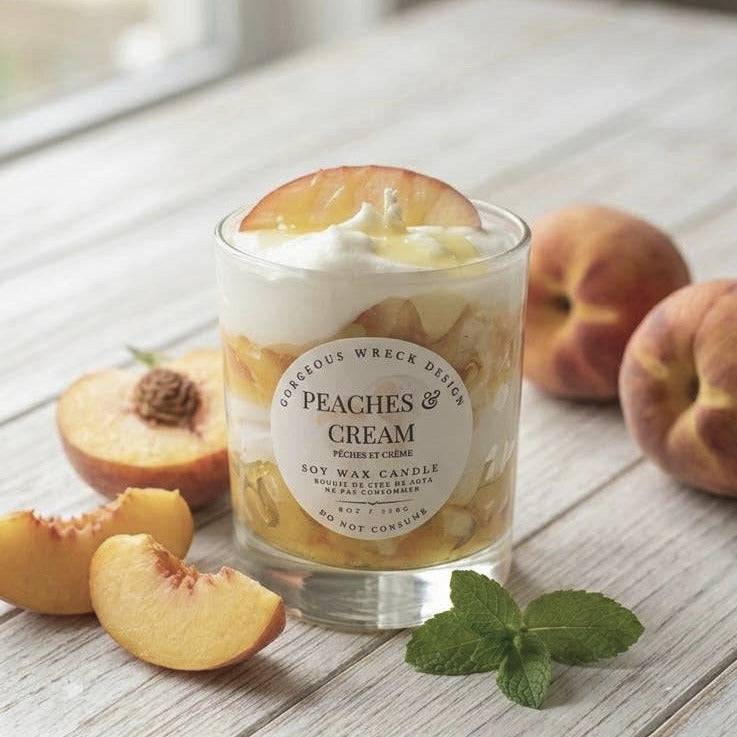 Peach-themed candle with peaches and cream flavor on a wooden surface