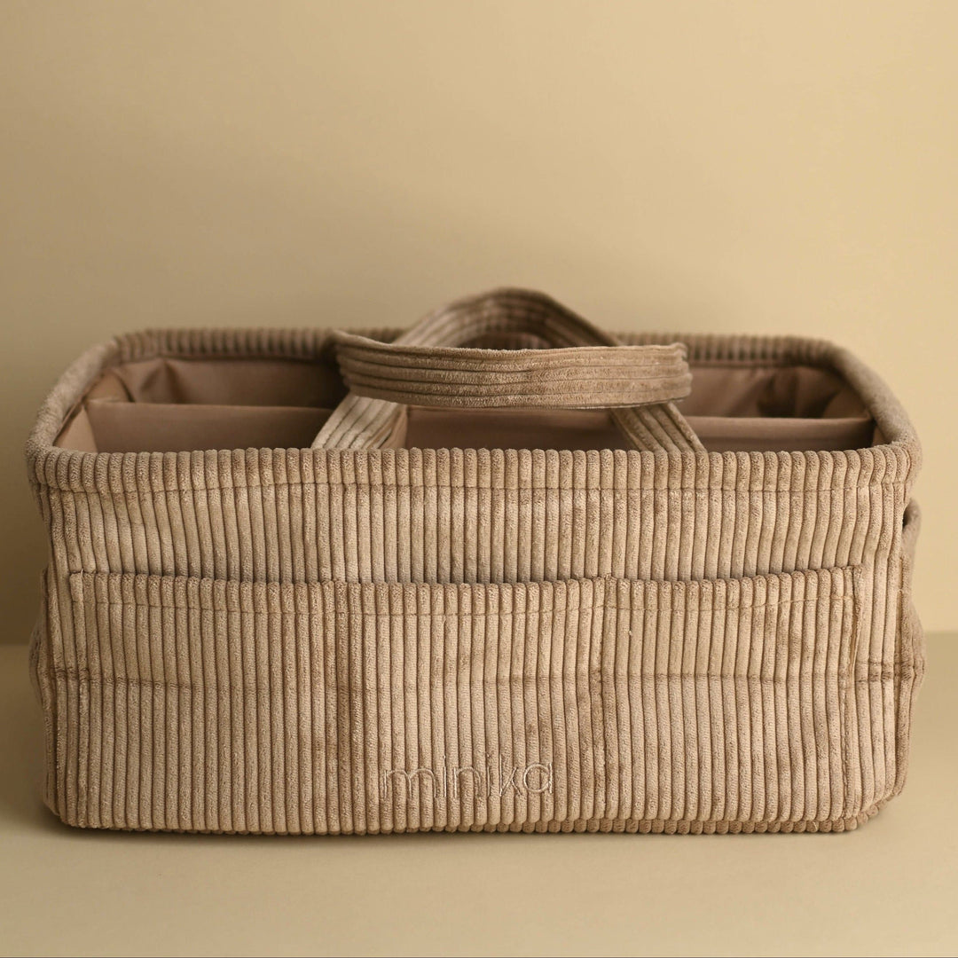 Beige woven basket with a handle on a beige background