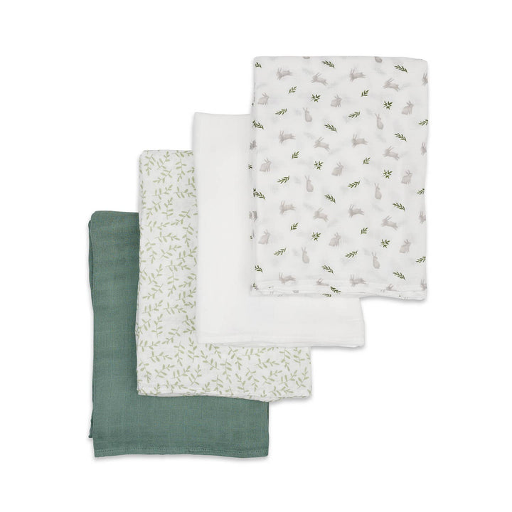 Set of three fabric swatches in green and white patterns on a white background