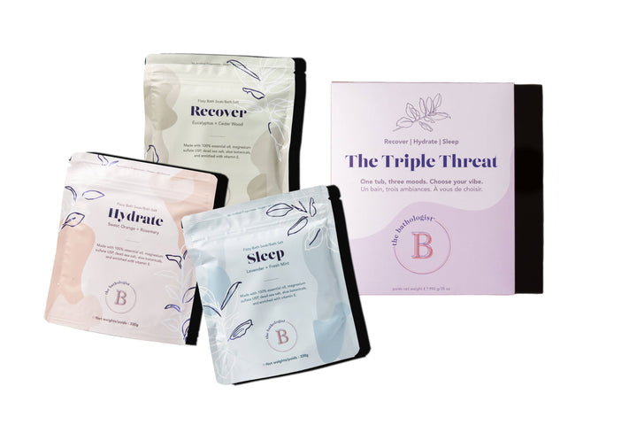 Four stand-up pouches and a matching box for a sleep and recovery product set on a white background. The packaging features soft pastel colors: cream, light pink, light blue, and lavender, with black borders and black text.