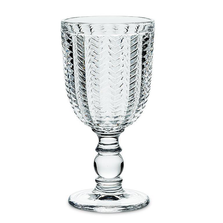 Clear glass goblet with textured design on a white background