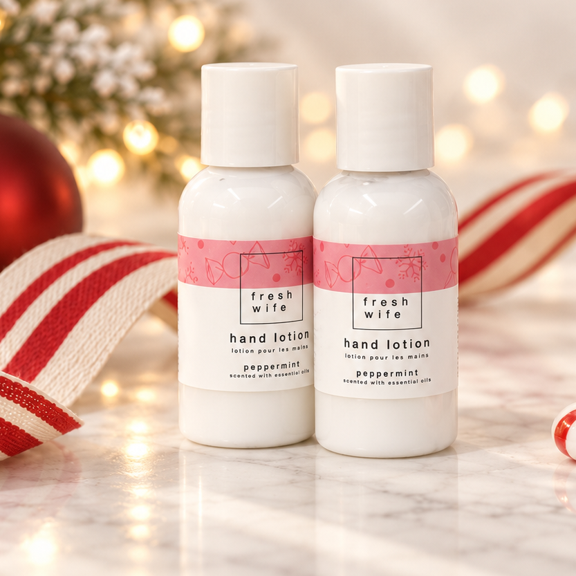 Two small white hand lotion bottles with pink labels reading &