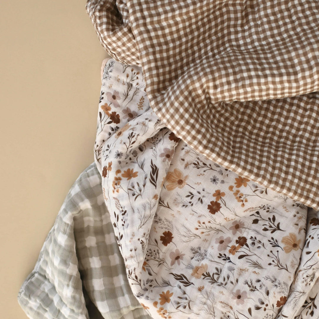 Three pieces of fabric with different patterns on a beige background