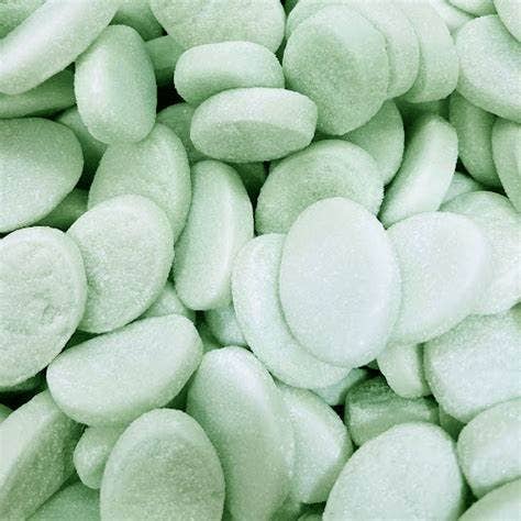 A close-up pile of smooth, rounded light mint-green decorative stones or pebbles filling the frame.