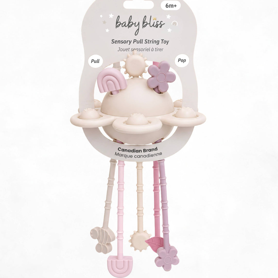 Baby Bliss sensory pull string toy in its original packaging, featuring a cream-colored teething ring with pastel pink and lavender accents, and three dangling sensory bars in pink, cream, and lavender.
