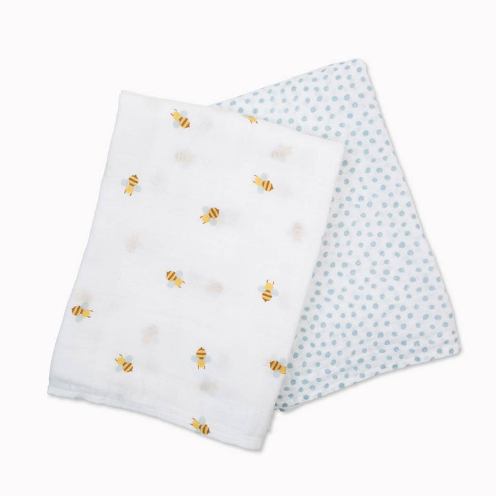 Two baby blankets with bee and polka dot patterns on a white background