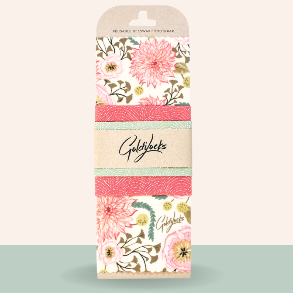 Goldilocks reusable beeswax food wrap with floral design on a light beige background