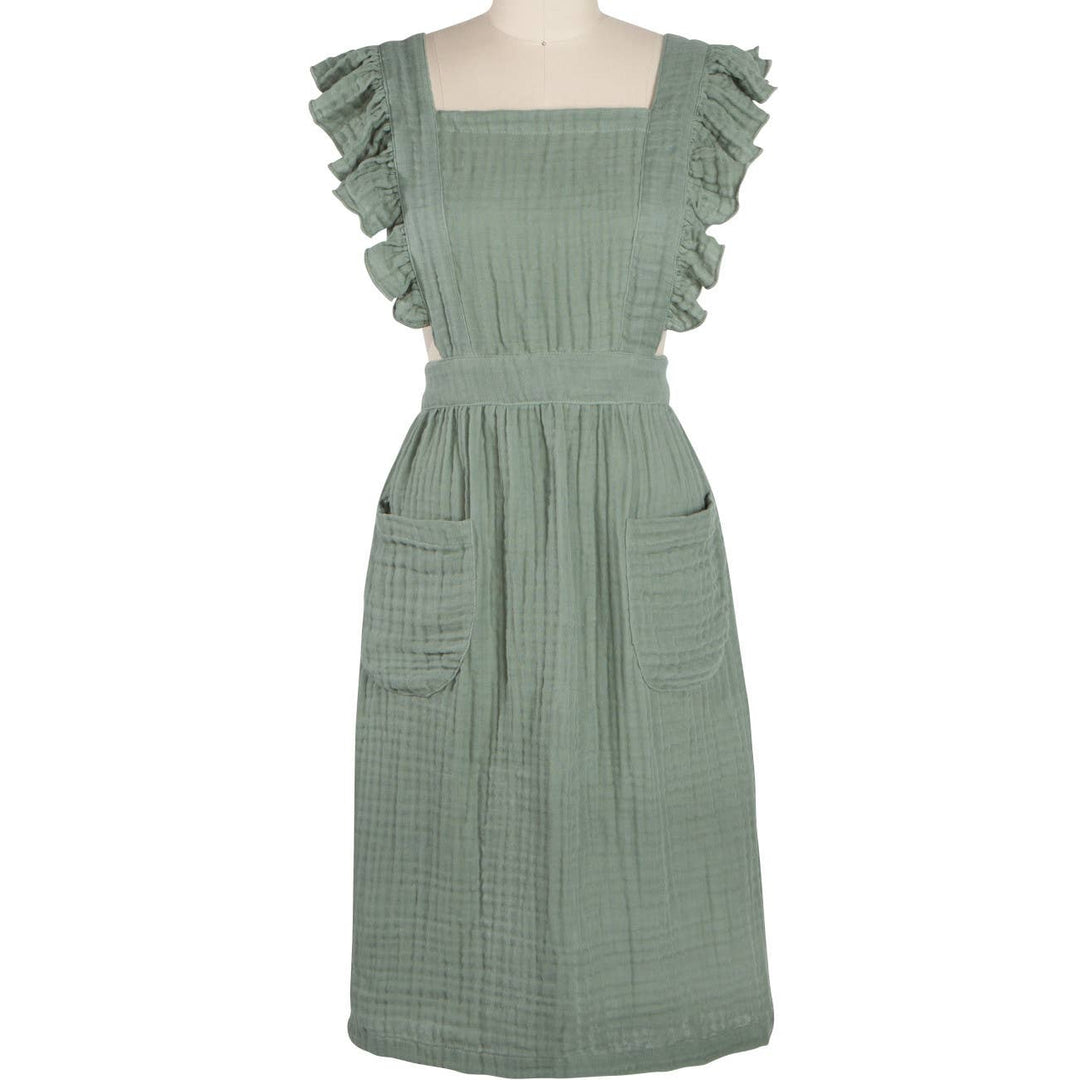 Green dress on a mannequin against a white background