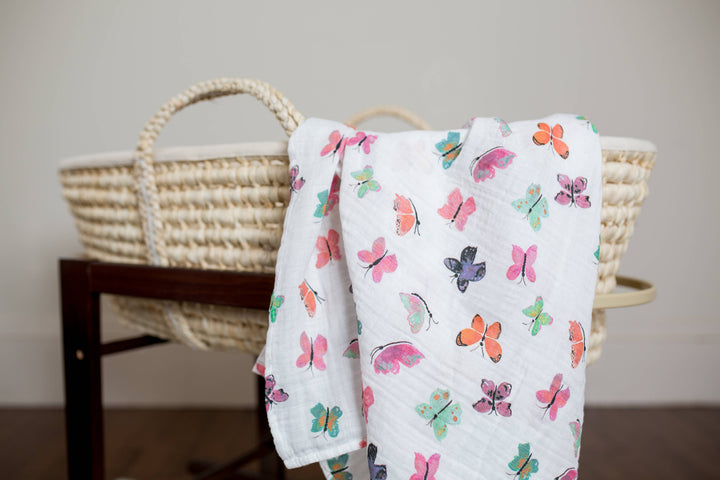 Lulujo Baby muslin swaddle blanket with butterfly print, soft and breathable fabric for cozy baby swaddling.