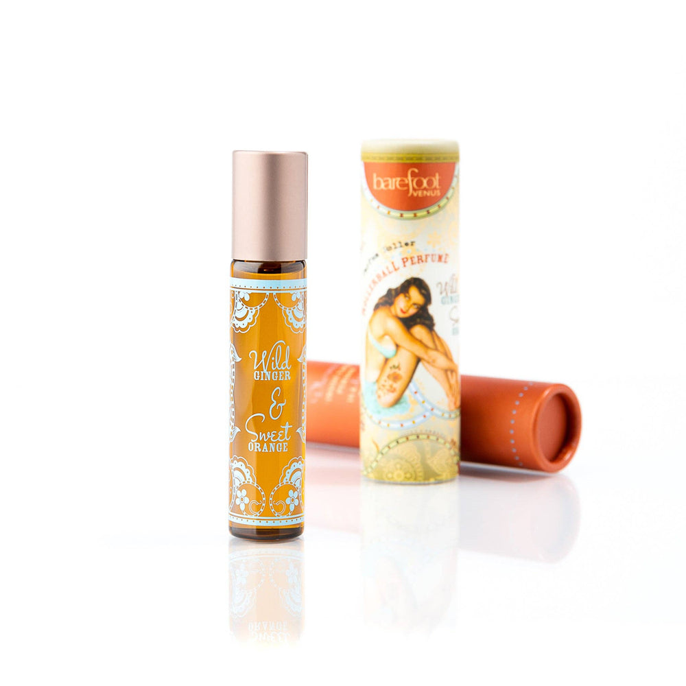 Two bottles of Wild Ginger & Sweet Orange perfume on a white background