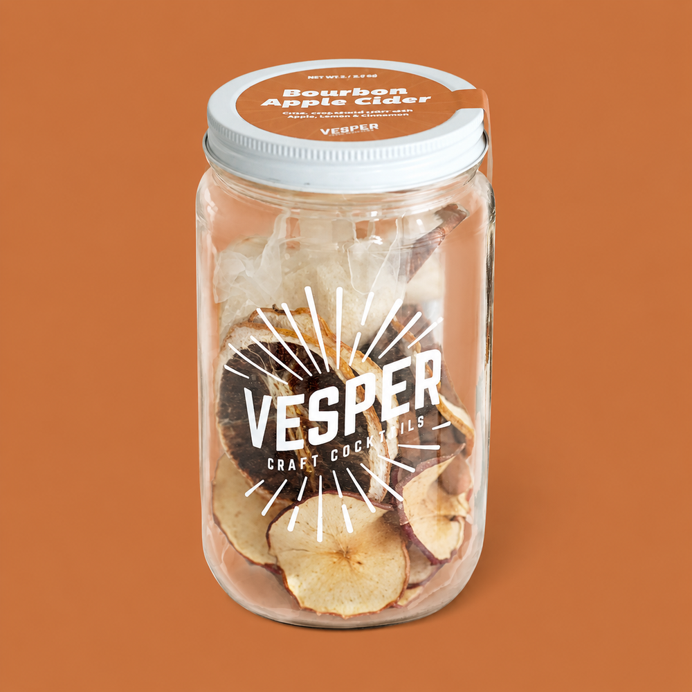 Jar of Vesper bourbon apple chips on a brown background