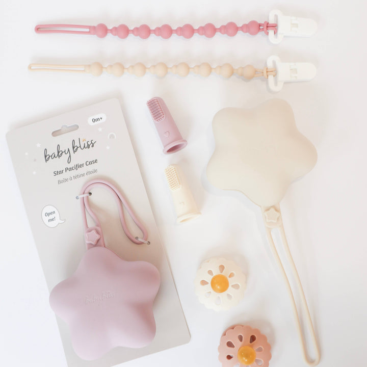Baby care products including a pacifier case, pacifier, and teether on a light background