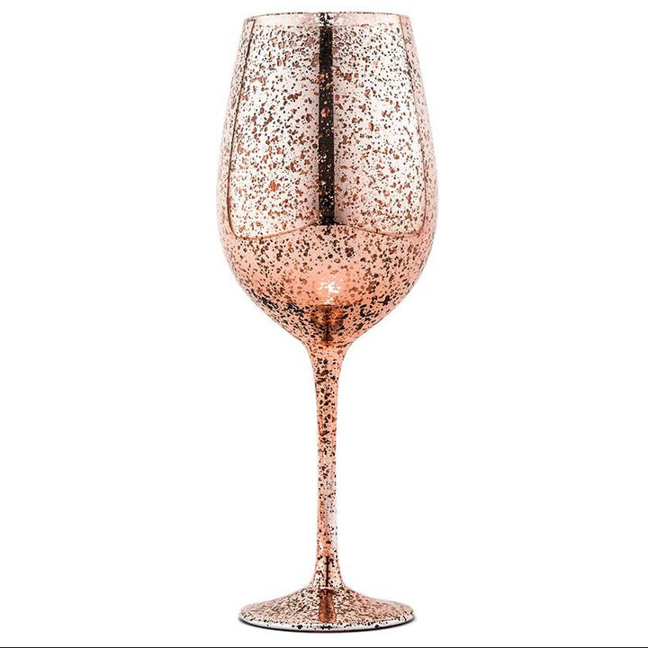 Rose gold glittery wine glass on a white background