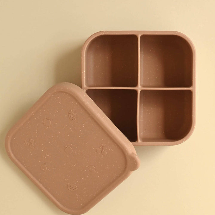 Brown bento box with lid on a beige background