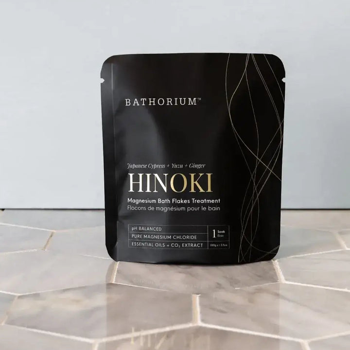 Bathorium Hinoki package on a tiled floor with a light gray wall background