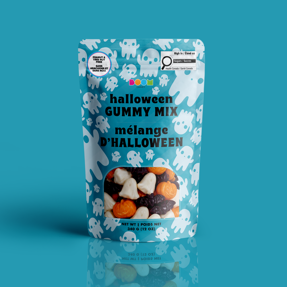 A stand-up pouch of Halloween Gummy Mix with a light blue background, white ghost illustrations, and a clear window showing the candy mix inside. The packaging features the text 'halloween GUMMY MIX mélange D'HALLOWEEN' and includes a circular 'Made in Canada' seal and a 'High in Fiber' badge.