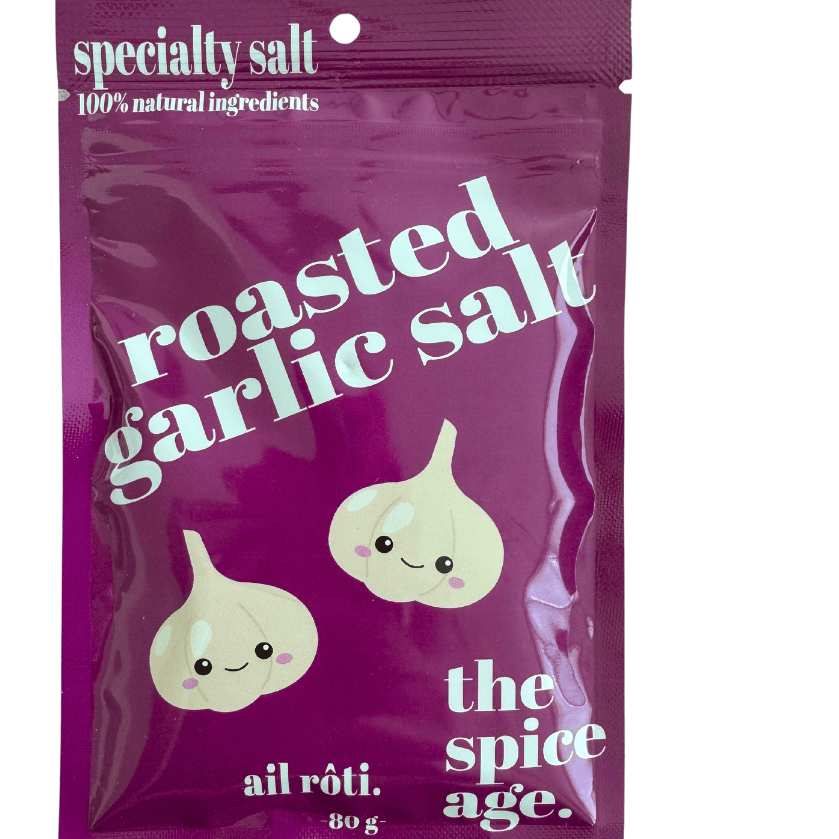 Jar of savory garlic salt from The Spice Age in a pantry setting, showing the seasoning with garlic and salt crystals.