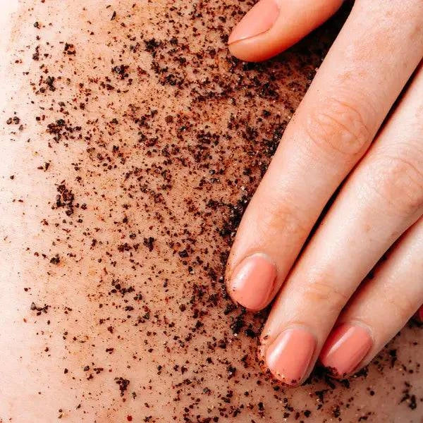 Vegan coconut coffee scrub in a jar, natural bath and body product by Epic Blend, showing the textured scrub with coconut and coffee ingredients.