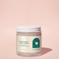 A clear jar containing a coffee bean body scrub with a white lid and a label that reads 'Coffee Bean Body Scrub'.