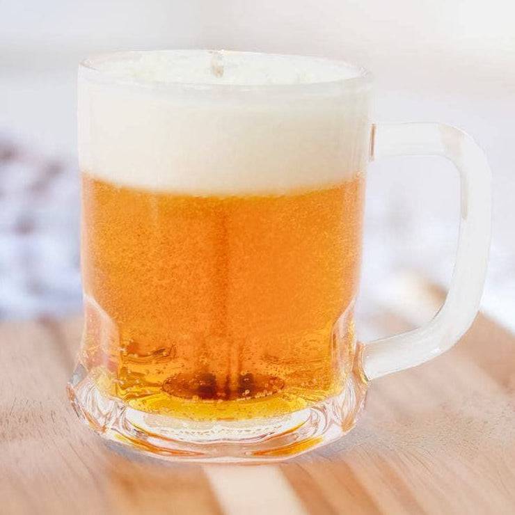 Clear mug with beer on a wooden surface