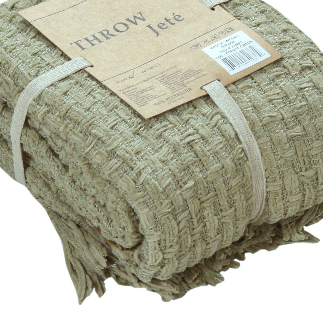 A folded woven throw blanket in a natural beige jute material, wrapped with a paper band label that reads &
