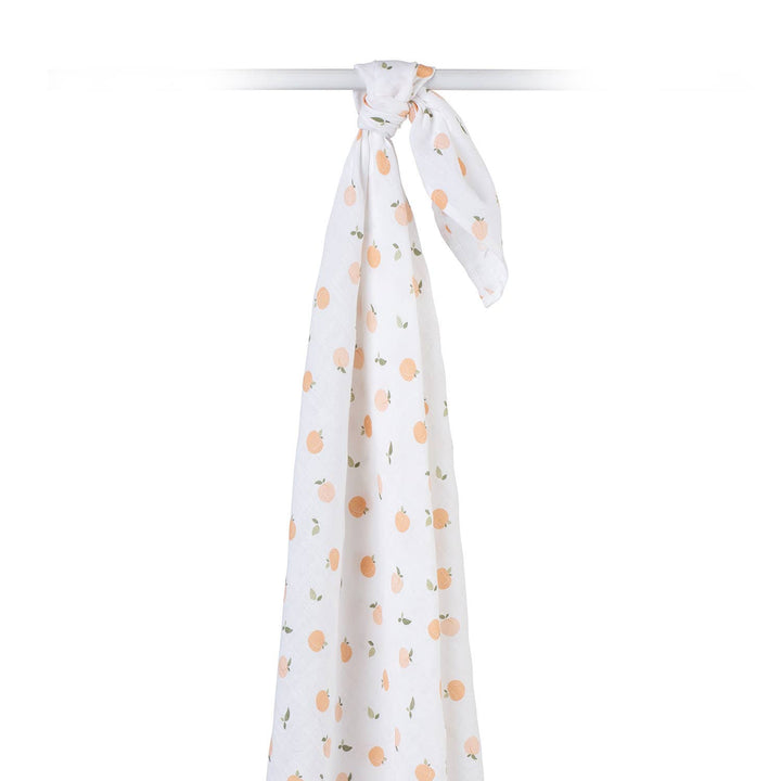 Lulujo Baby muslin cotton swaddle blanket with peach print, soft and breathable for newborns and infants.
