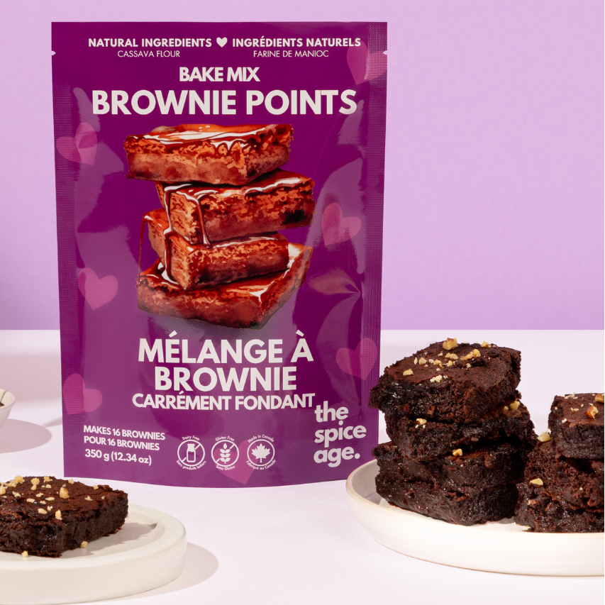 Bake mix packaging for brownie points with brownies and a spoon on a purple background