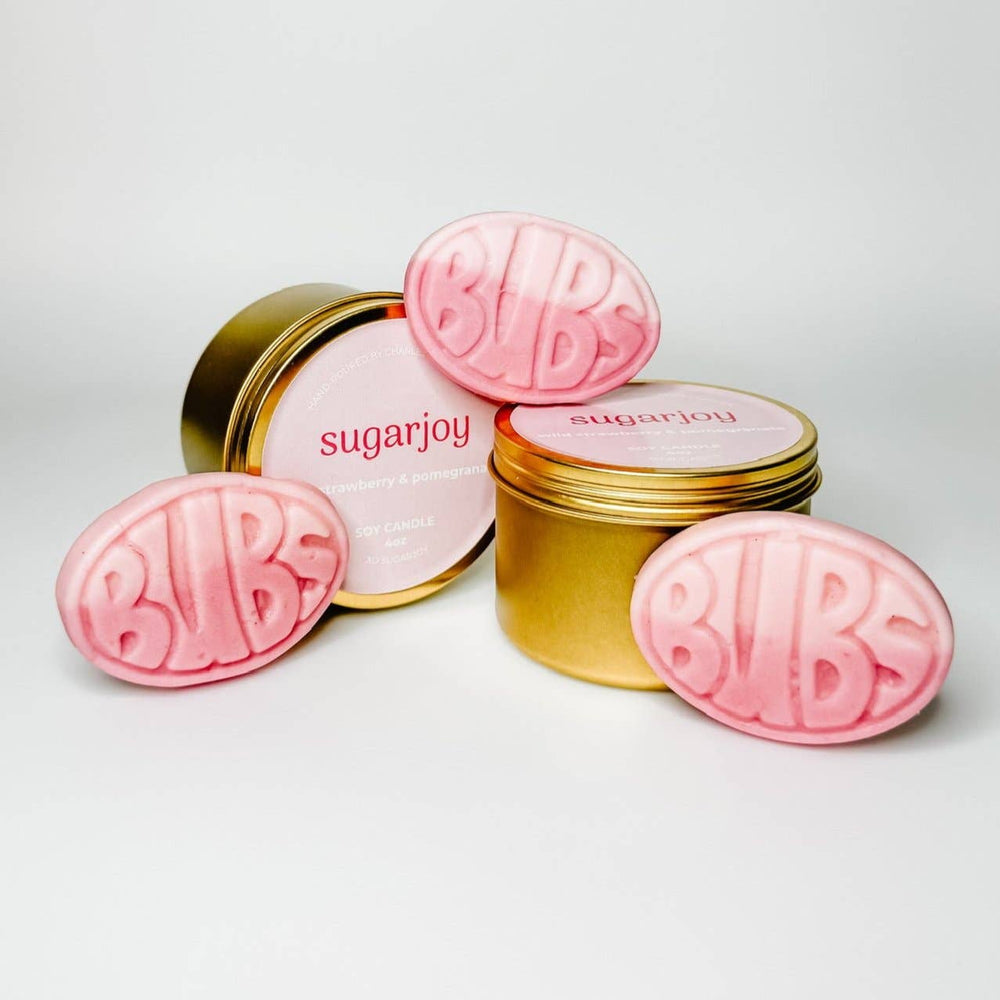 Pink 'BUBS' and gold containers with 'sugarjoy' branding on a light gray background