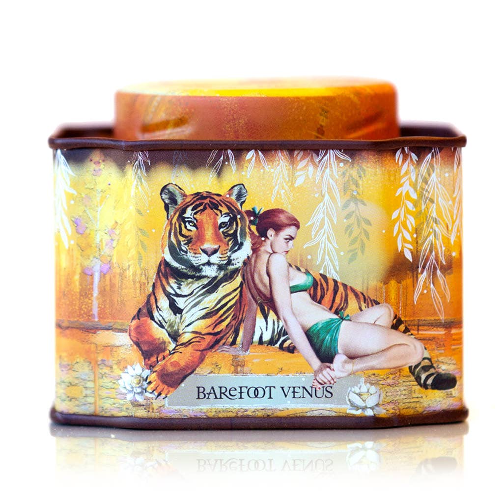 Tin container with a tiger and woman design, featuring the brand 'Barefoot Venus'.