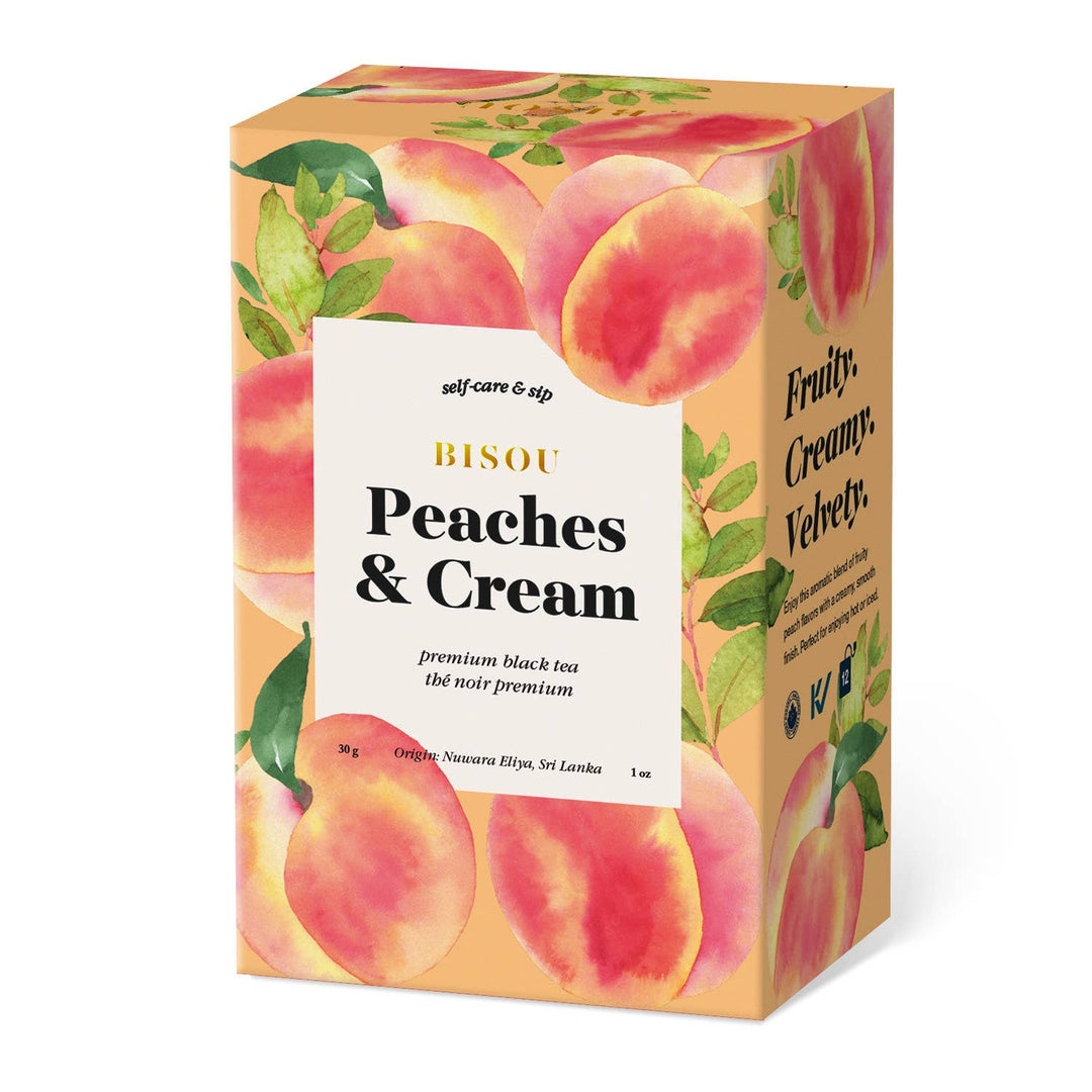 Box of Bisou Peaches &amp; Cream premium black tea with peach illustrations on a white background