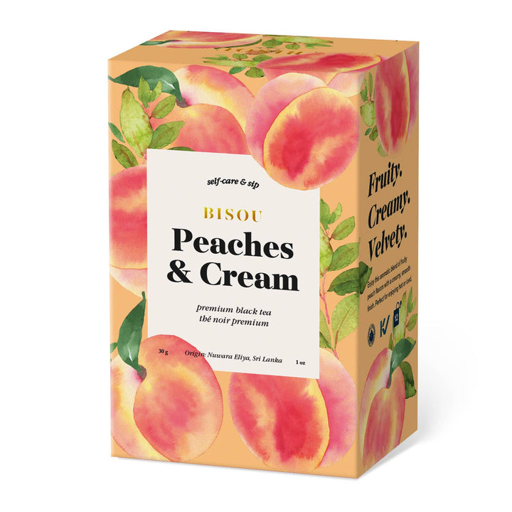 Box of Bisou Peaches &amp; Cream premium black tea with peach illustrations on a white background