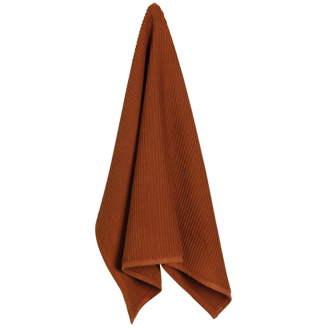Brown towel folded on a white background