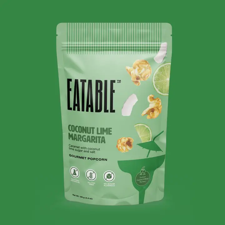 Eatable Coconut Lime Margarita popcorn bag on a green background