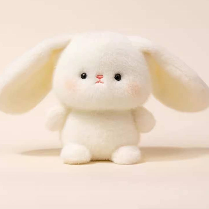 Cute plush bunny toy on a beige background