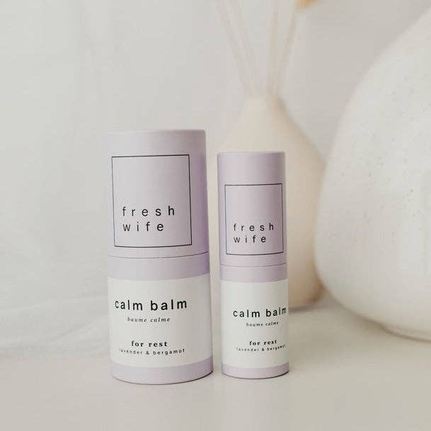 Two 'fresh wife' calm balm containers on a light background