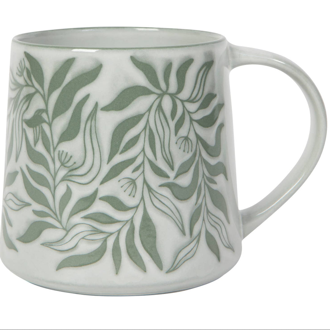White mug with green leaf pattern on a white background