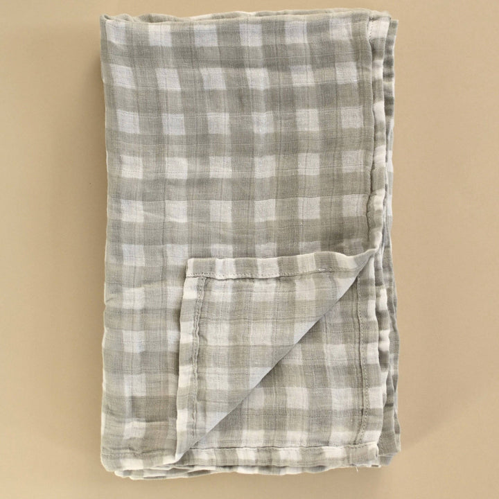 Folded checkered fabric on a beige background