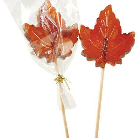 Two leaf-shaped lollipops on sticks with a clear bag containing more lollipops on a white background.