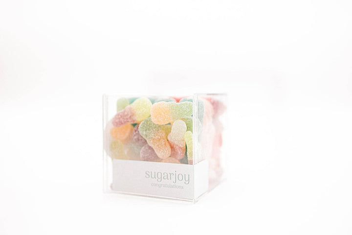 Clear cube container filled with colorful gummy bears labeled &